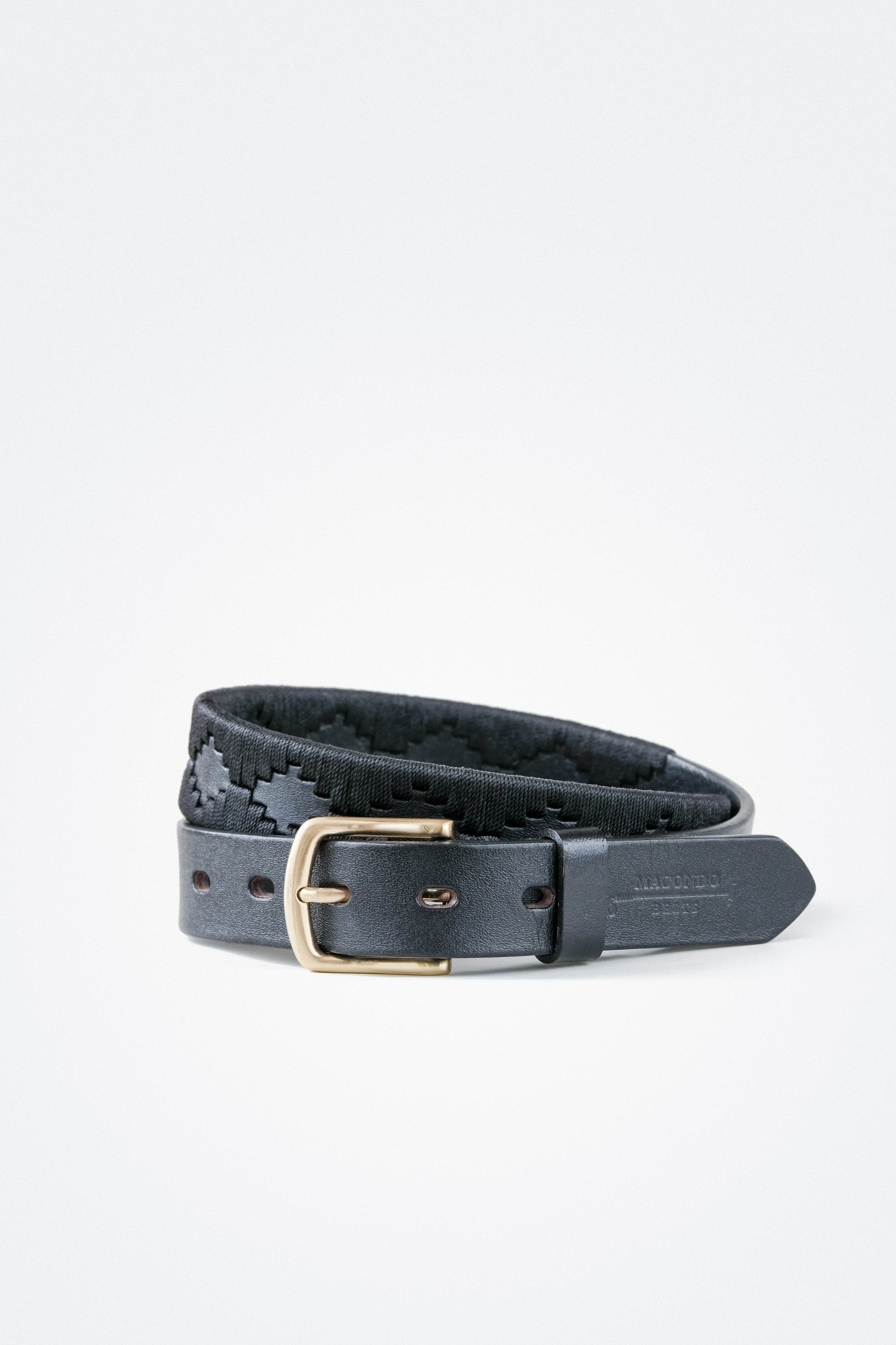 Ace Rivington Macondo Belt - Petrolero. The black leather belt features a gold buckle and a woven pattern running along its length. The belt is displayed on a plain white background.