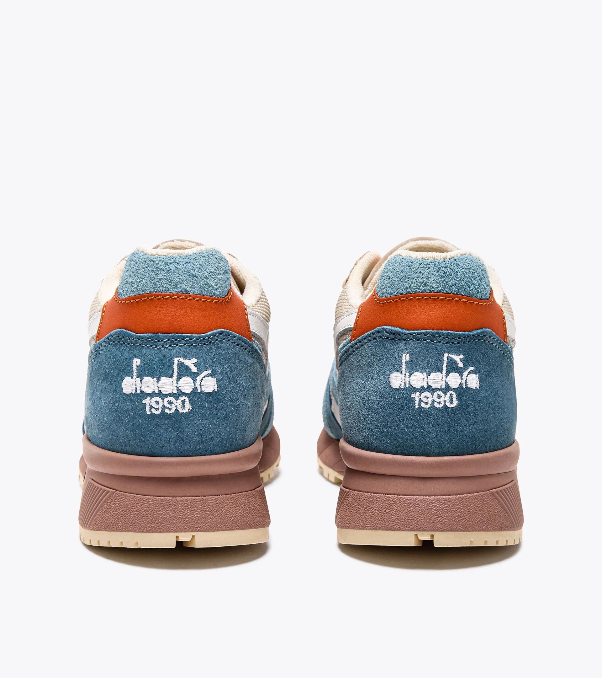 Rear view of a pair of Ace Rivington Diadora - N9000 Tourney Italia - Blue features a combination of blue suede, beige, and brown leather accents. The Diadora logo and '1990' are embroidered in white on the heel.