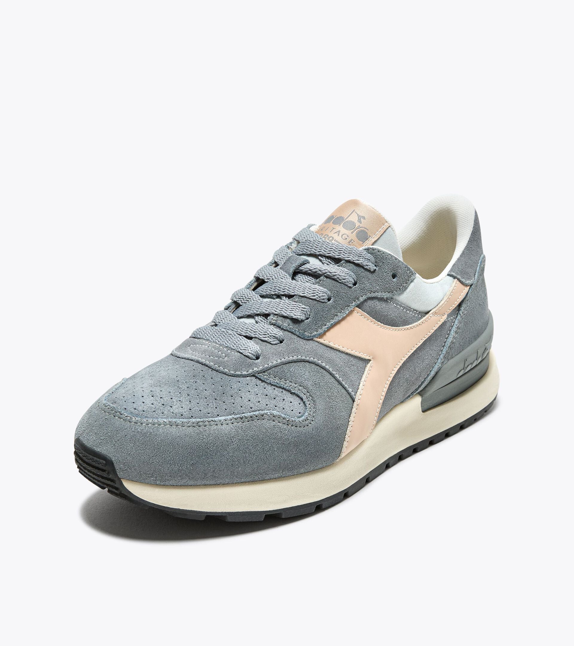 Ace Rivington Diadora Conquest Suede SW - High Rise sneaker in gray suede with a beige accent on the side. The shoe features a perforated toe box, gray laces, and a cushioned white interior. The sole is off-white with a black tread.