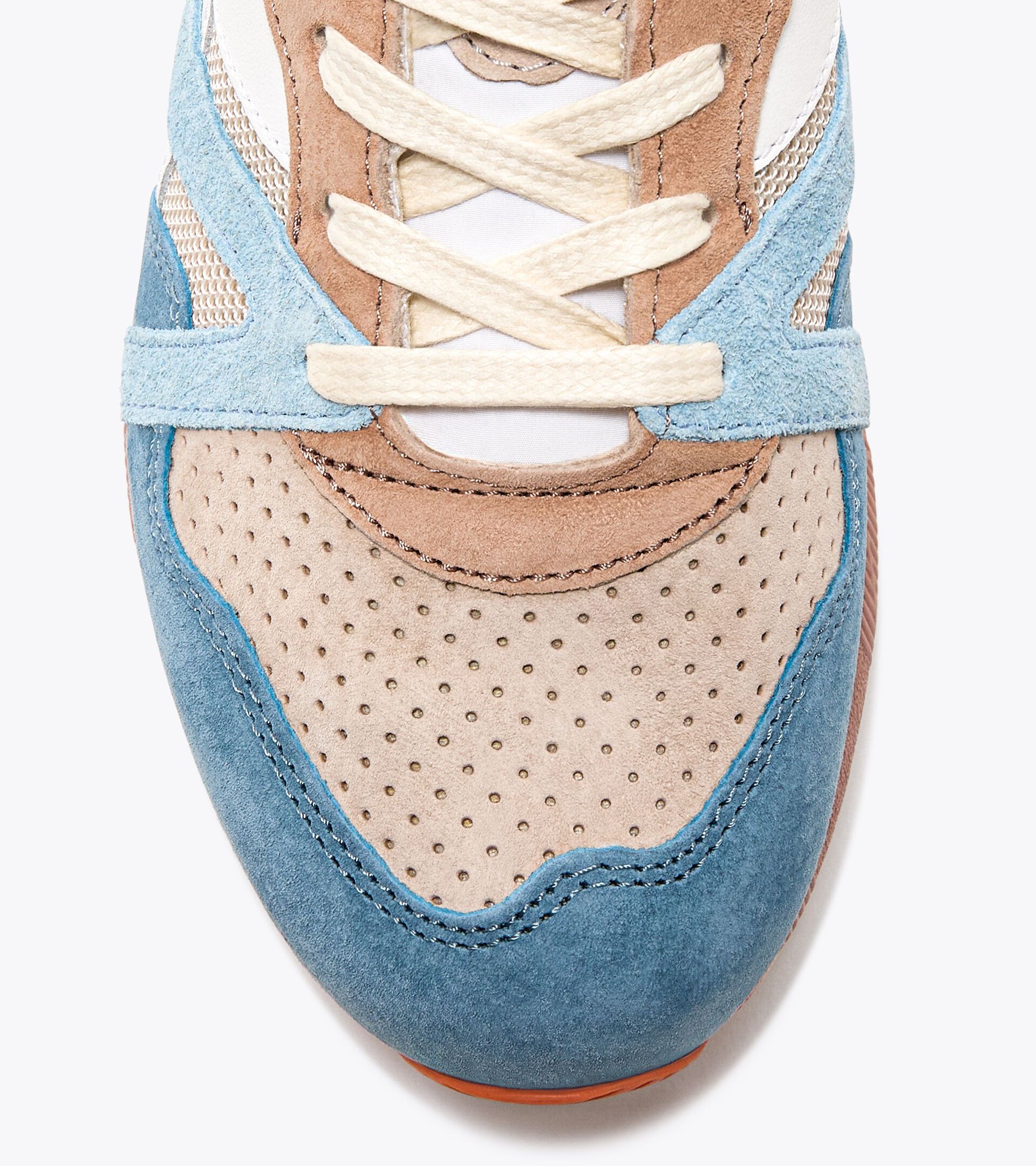 Close-up view of the toe area of an Ace Rivington Diadora - N9000 Tourney Italia - Blue features a combination of blue, beige, and brown suede with perforated detailing on the beige section. The laces are cream-colored, and the stitching is visible throughout the design.