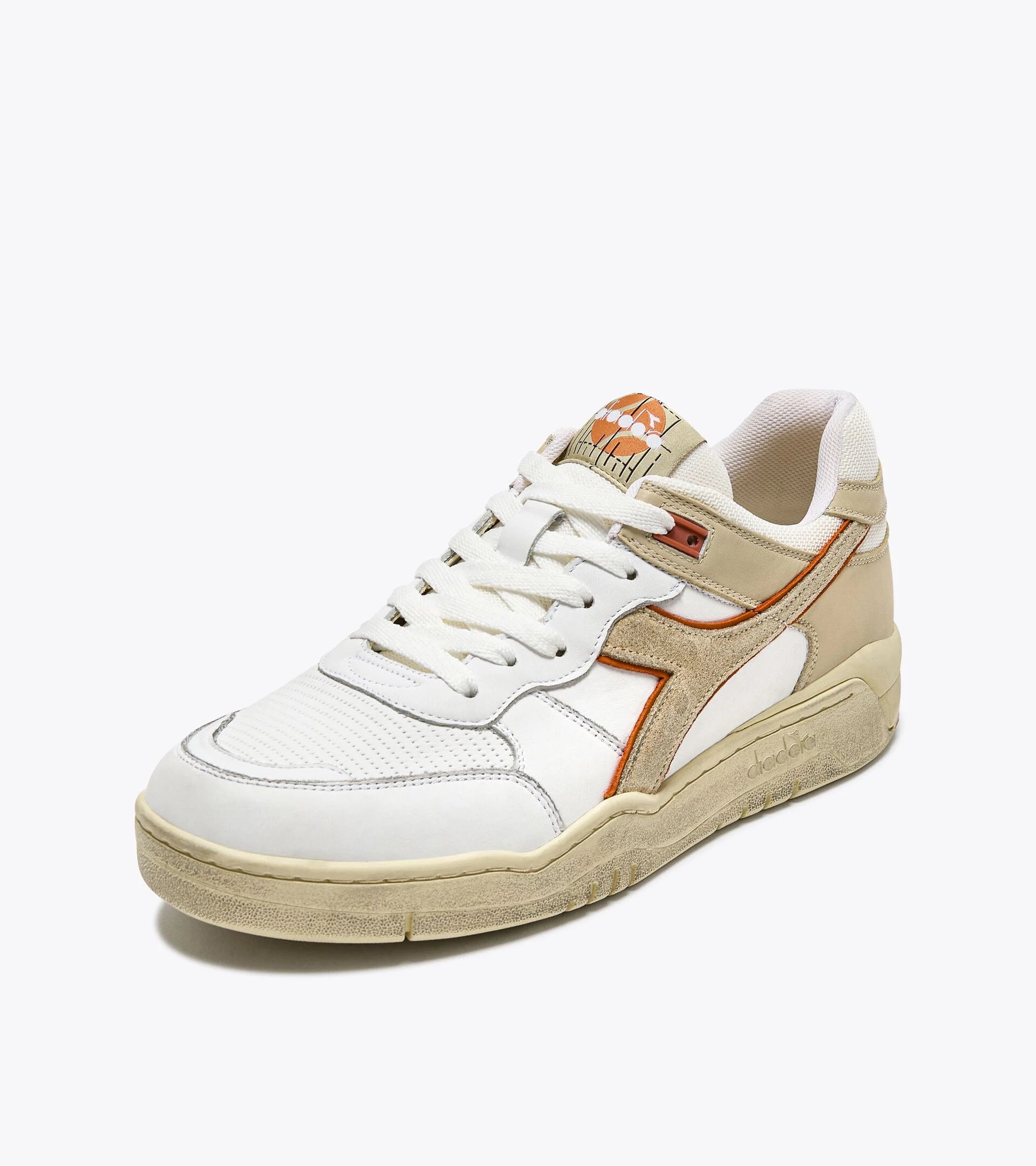 Ace Rivington Diadora B. 560 USED - Beige Bleached shoe features a combination of white leather and beige suede with orange accents. It has a white lace-up closure, a beige rubber sole, and a logo on the tongue.