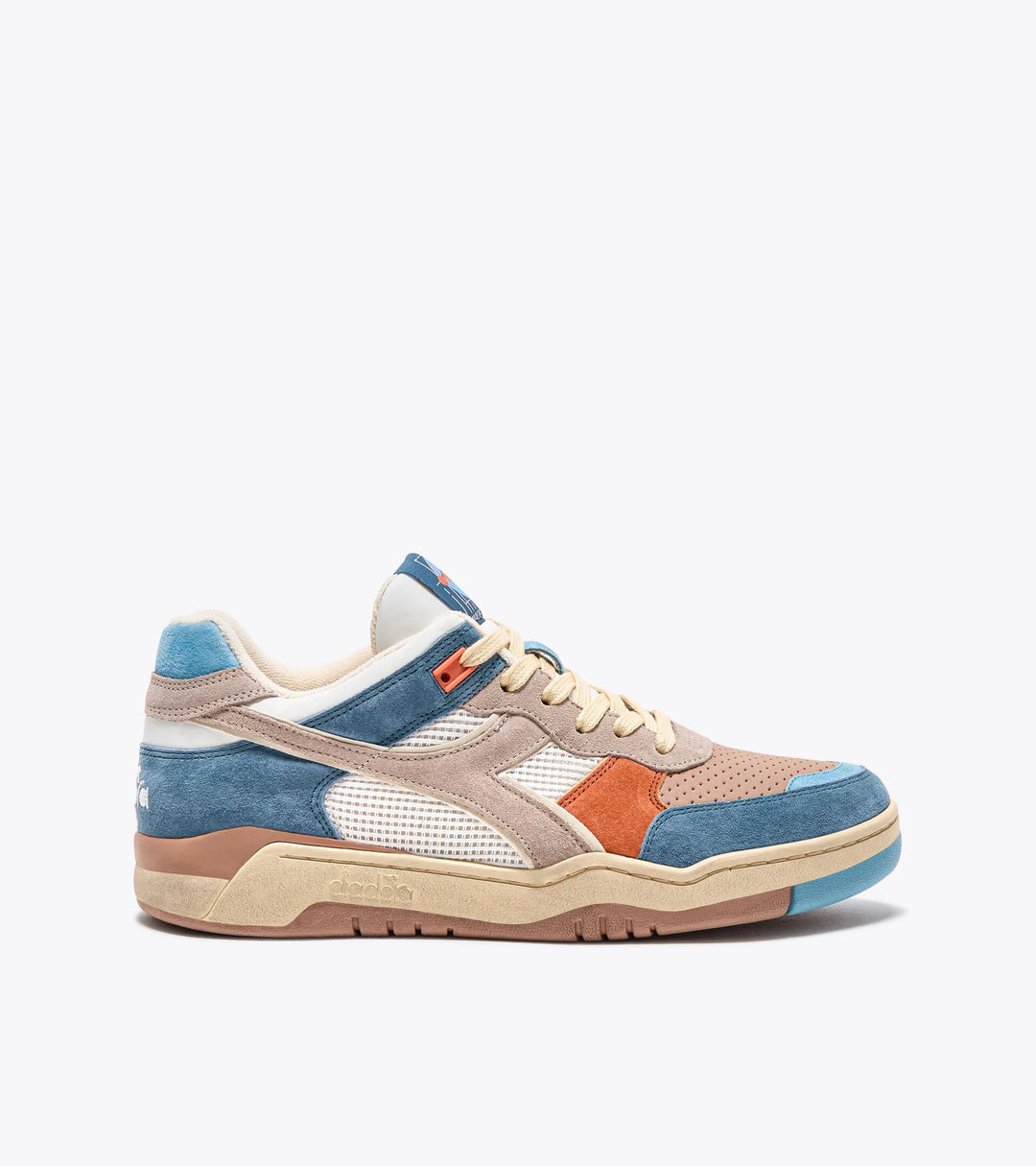 Side view of Ace Ace Rivington Diadora B. 560 USED - Tourney Italia sneaker shoe features a mix of blue, beige, and orange suede overlays, with white mesh panels and a beige rubber sole. The design includes perforated detailing on the toe box and a combination of beige and blue accents on the heel and tongue.