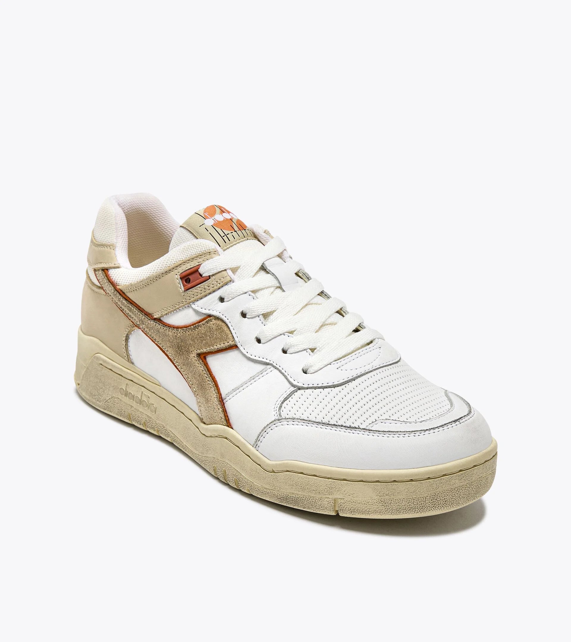 Ace Rivington Diadora B. 560 USED - Beige Bleached shoe features a combination of white leather, beige suede, and orange accents. The design includes perforated detailing on the toe box, a beige midsole with a slightly worn look, and white laces. The Diadora logo is prominently displayed on the side and tongue of the shoe.