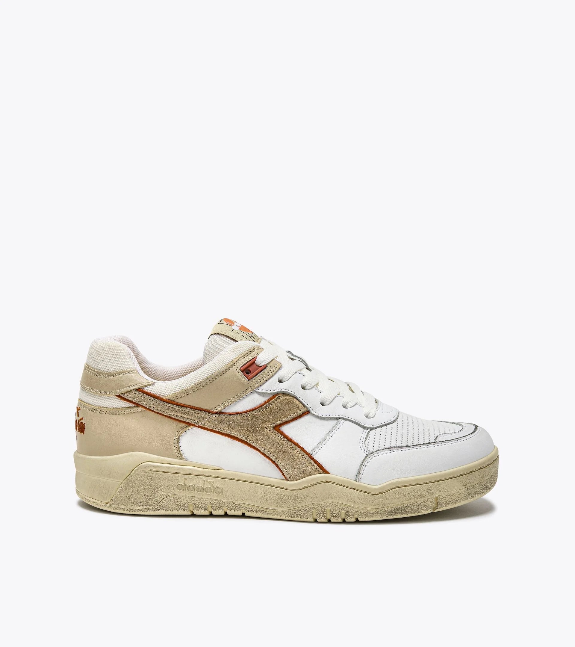 Side view of an Ace Rivington Diadora B. 560 USED - Beige Bleached shoe features a combination of white leather and beige suede with a distinctive red Diadora logo on the side. It has a vintage, worn-in look with a textured sole and lace-up closure.