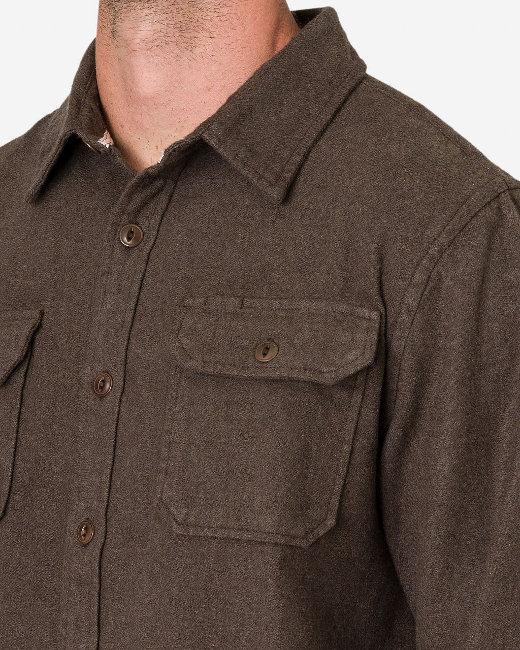 A close-up shows a man wearing an Ace Rivington flannel utility shirt in Cedar color. The shirt features a collar and buttoned chest pockets on both sides made of heavy brushed flannel, providing a thick, warm texture that is ideal for cooler weather.