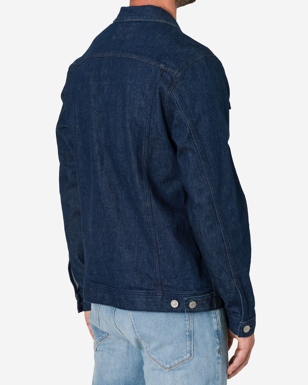 Man wearing a Dark Rinse Denim Jacket by Ace Rivington paired with light blue jeans, shown from the back. The jacket has visible stitching and button details on the cuffs and waistband.