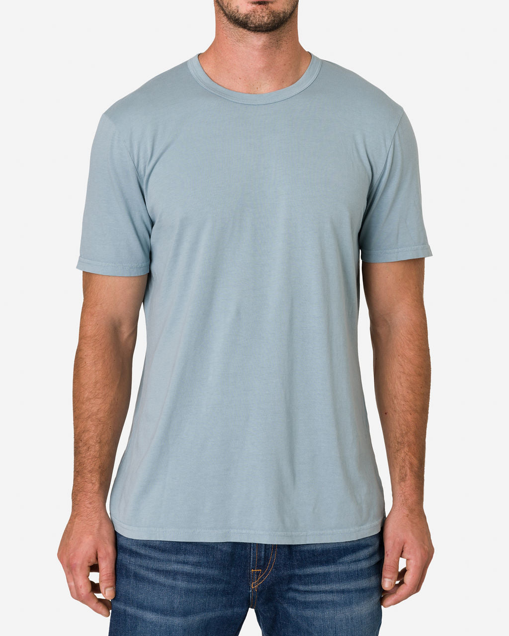 Man wearing an Ace Rivington Super Soft Supima Cotton Tee - Horizon Blue paired with blue jeans while focusing on his upper body. The T-shirt has a simple, classic design with a crew neck and short sleeves. The fabric appears soft and comfortable.