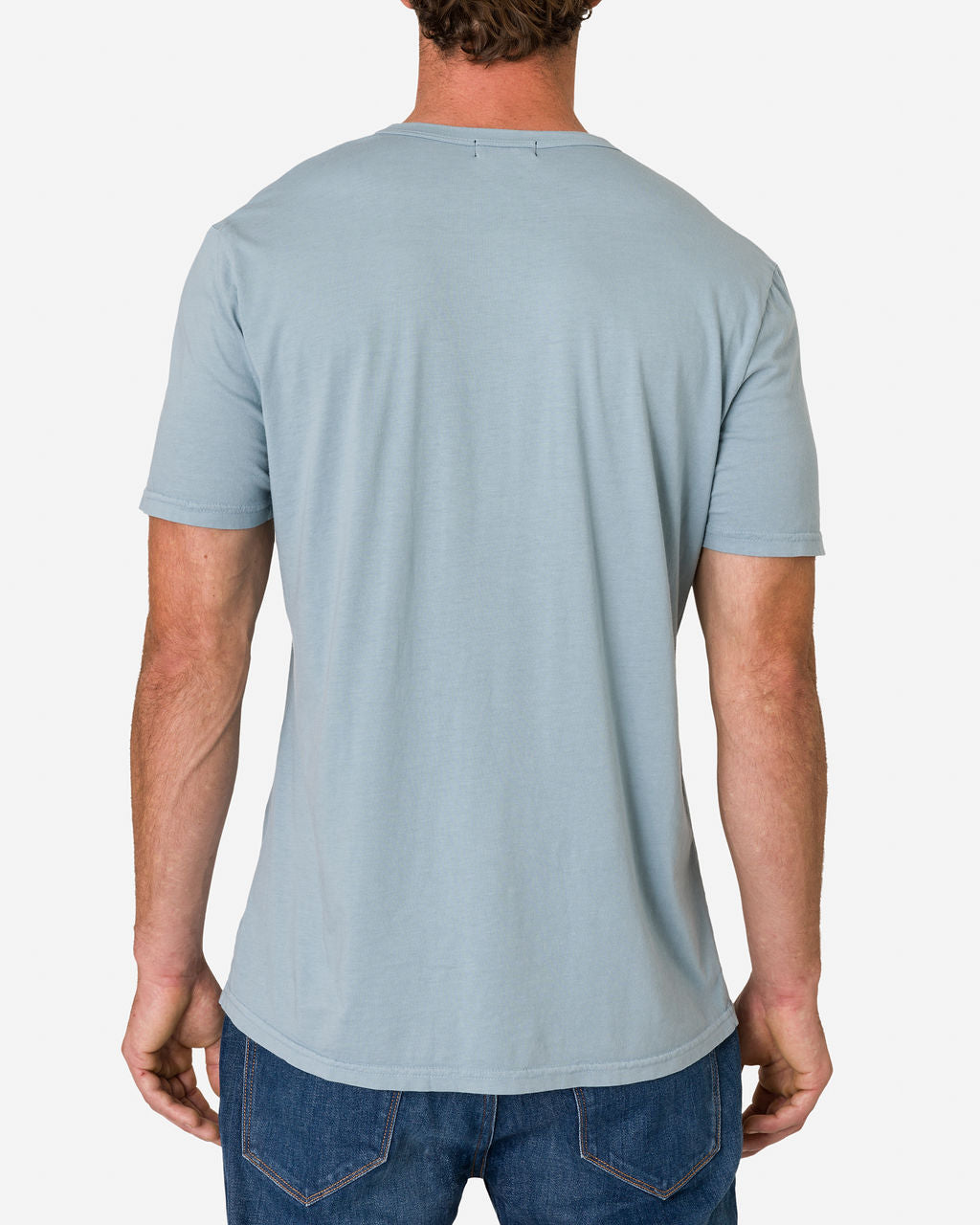 Man shown from the back wearing an Ace Rivington Super Soft Supima Cotton Tee - Horizon Blue paired with blue jeans. The T-shirt has a simple design with short sleeves and a slightly curved hem. The image highlights the fit and style of the T-shirt, showcasing its casual and comfortable look.