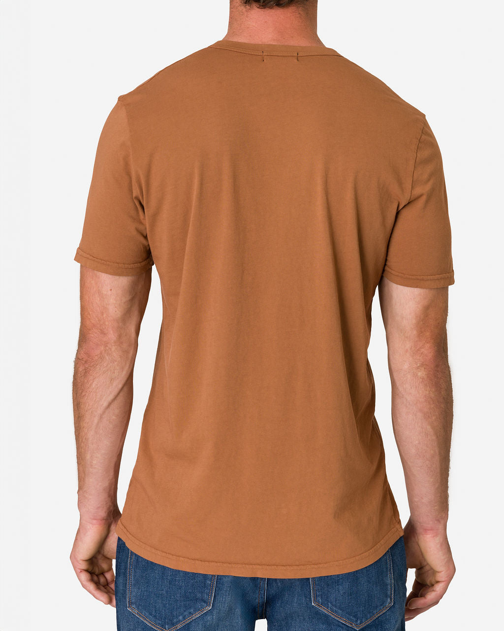 Man wearing a sienna-colored Ace Rivington Super Soft Supima Cotton Tee paired with blue jeans. The image shows the back view of the T-shirt, highlighting its simple design which appears to be comfortable and well-fitted.