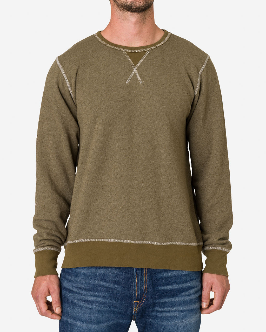 Man wearing an Ace Rivington French Terry Vintage Soft Crewneck Sweatshirt in Army Green color. Features a crewneck design with visible stitching details, including an 'X' stitch at the neckline and contrasting seams along the shoulders, sleeves, and hem. The person is also wearing blue jeans. The sweatshirt has a casual and comfortable appearance, suitable for everyday wear.