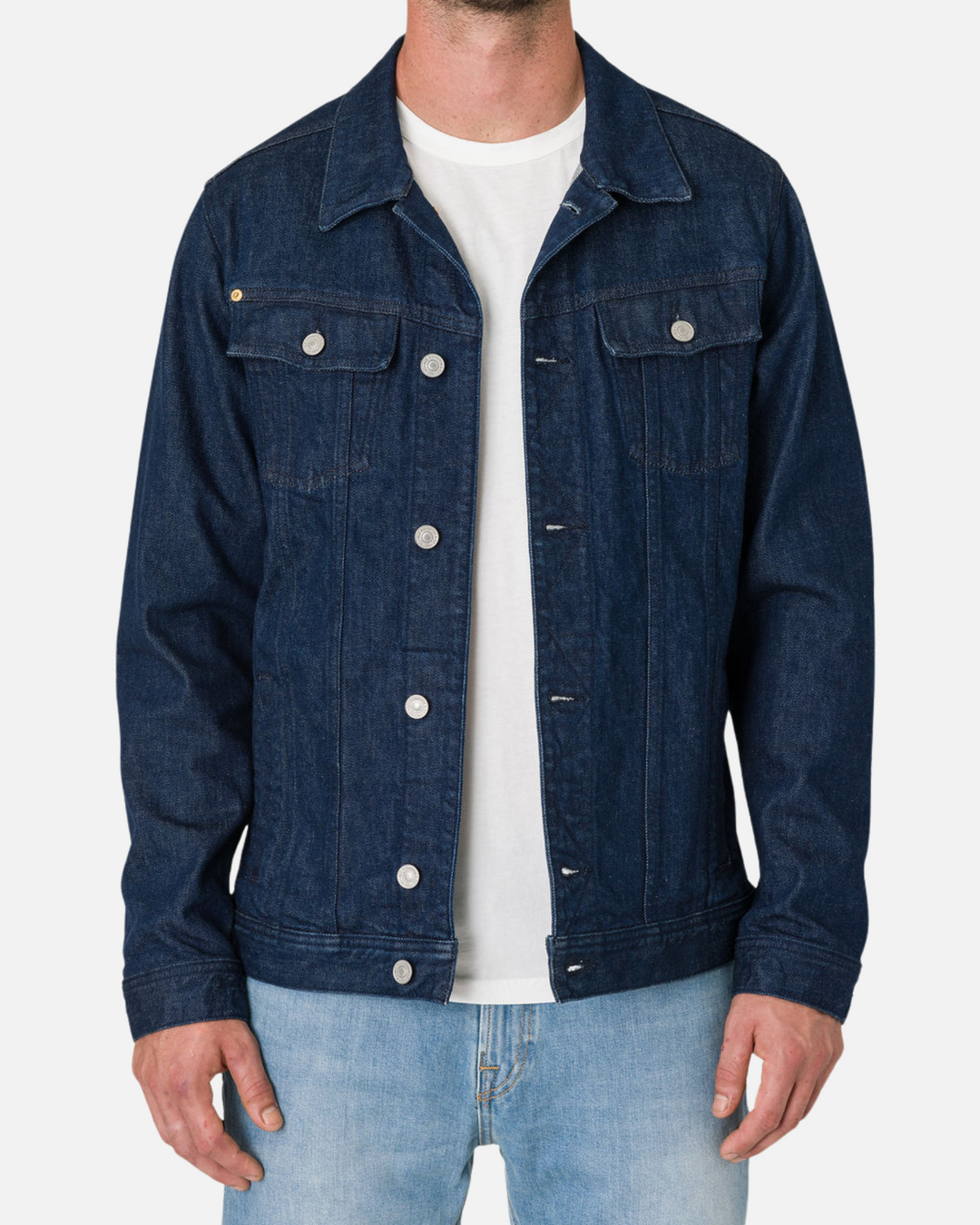 Man wearing an Ace Rivington Denim Dark Rinse Jacket over a white t-shirt and light blue jeans.