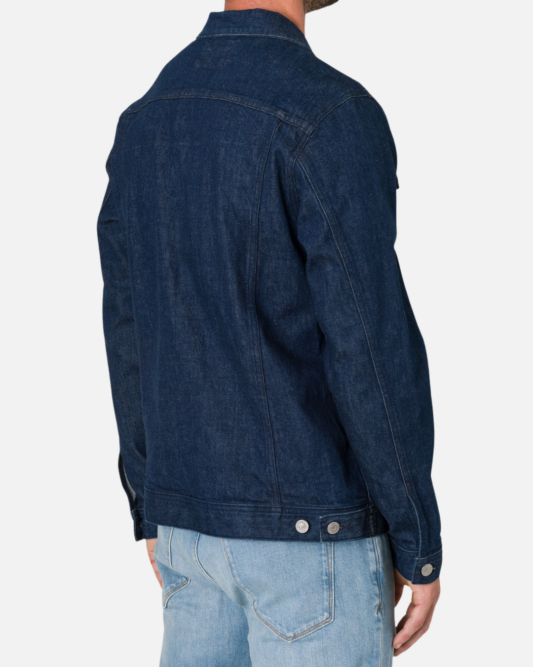 Man wearing a Dark Rinse Denim Jacket by Ace Rivington paired with light blue jeans, shown from the back. The jacket has visible stitching and button details on the cuffs and waistband.