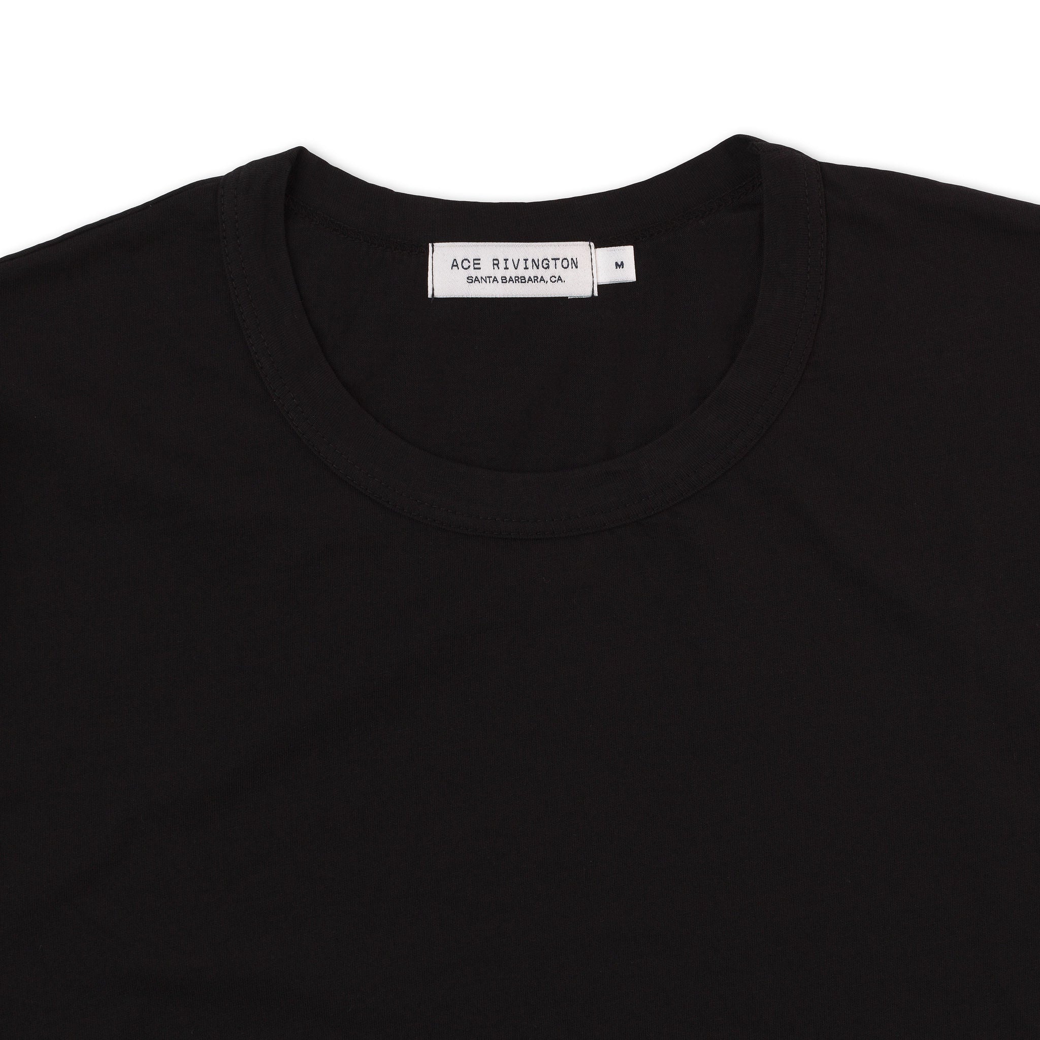 Close-up image view of a black color Super Soft Supima Cotton Tee, showing the neckline and the label inside the collar reads 'ACE RIVINGTON SANTA BARBARA, CA' and indicates the size 'M'.