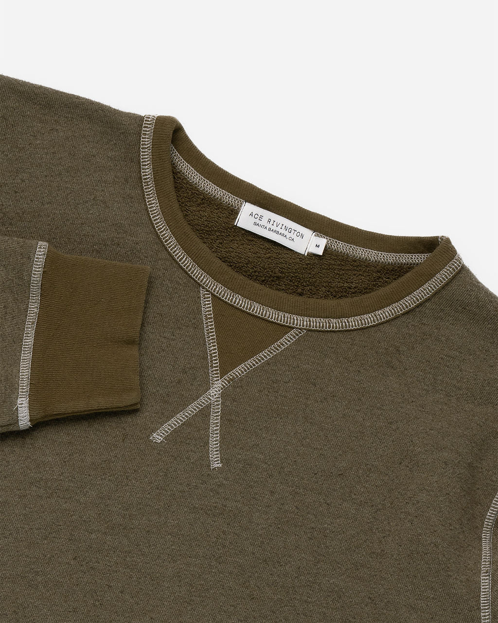 Close-up of a French Terry Vintage Soft Crewneck Sweatshirt in Army Green color. The image highlights the neckline and part of the sleeve, showcasing the detailed stitching and the soft texture of the fabric. The label inside the collar reads 'Ace Rivington, Santa Barbara, CA.' The sweatshirt features a distinctive 'X' stitch design below the neckline.