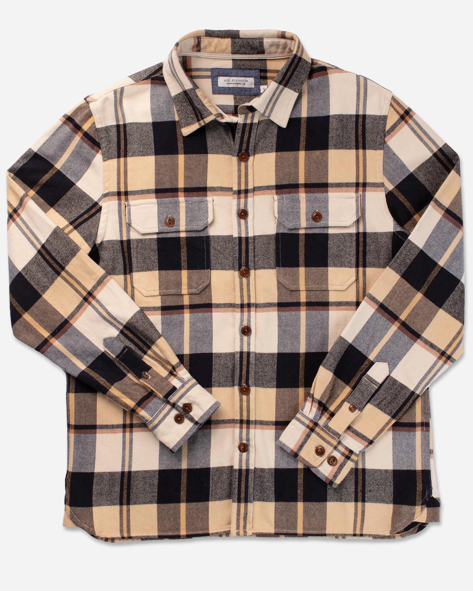 Ace Rivington Midnight Dune - Flannel Utility long-sleeve, button-up shirt with a plaid pattern in shades of beige, black, gray, and yellow. Features two chest pockets with buttoned flaps, a classic collar, and buttoned cuffs, made from 100% cotton heavy brushed flannel, it offers a super soft hand feel and has been heavily pre-washed to eliminate shrinkage. The shirt has a casual and timeless design, making it versatile for various occasions.