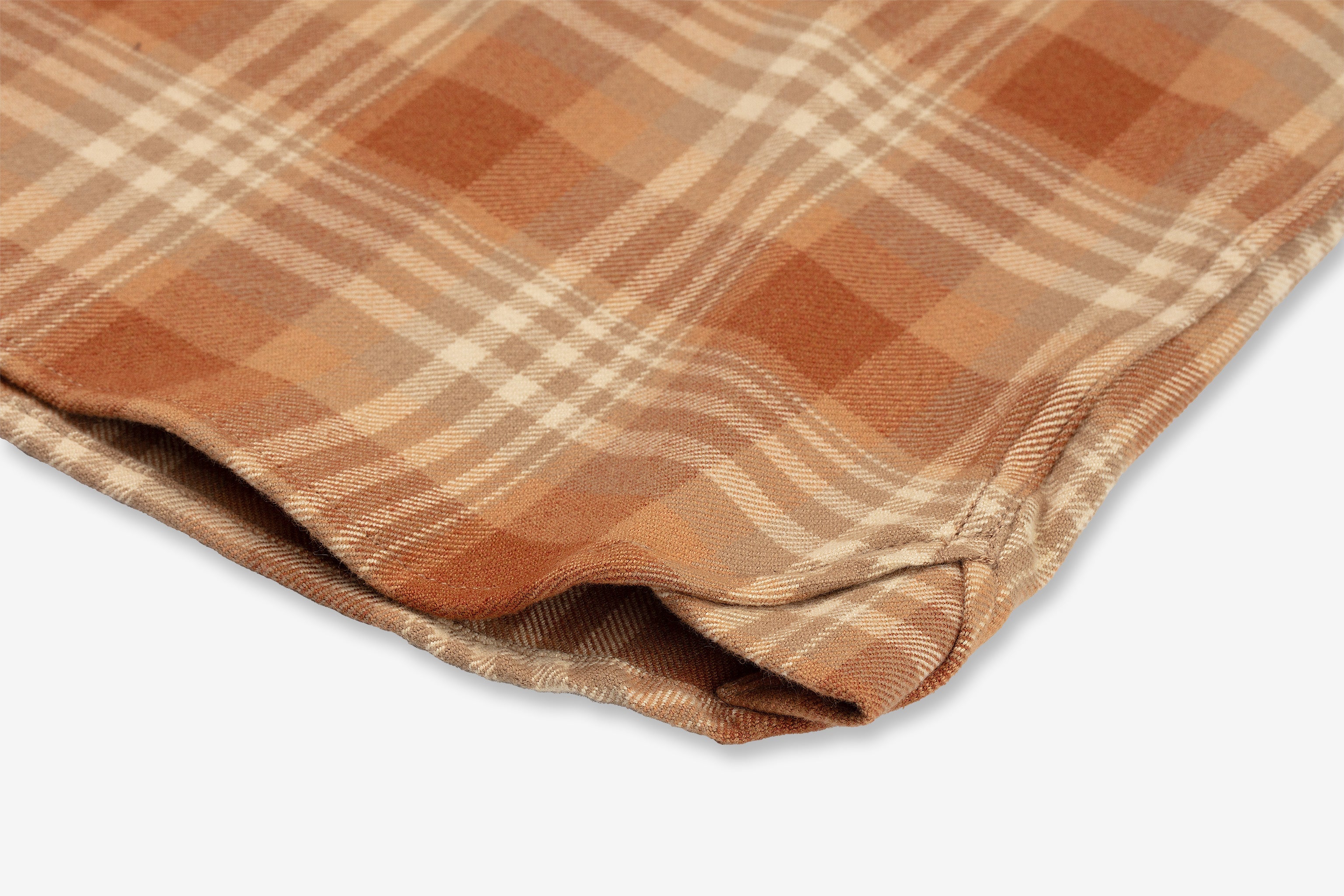 Close-up of a folded piece sand storm color flannel utility shirt fabric with a plaid pattern in shades of brown, orange, and beige by Ace Rivington. The fabric has a soft texture and a classic checkered design, highlighting its warmth and comfort. This detailed view showcases the intricate weave and color combination, making it appealing for textile, fashion, or interior design discussions.