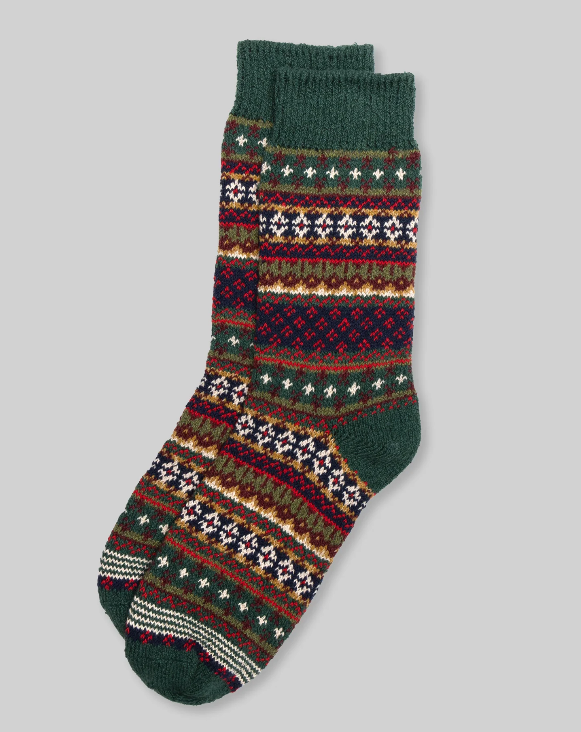 A pair of Ace Rivington American Trench Cotton Fair Isle Socks feature a traditional Fair Isle pattern with a mix of green, red, white, and brown colors. The intricate design includes various geometric shapes and stripes, giving the socks a festive and cozy appearance. The socks are laid flat against a plain background, showcasing their detailed pattern and texture.