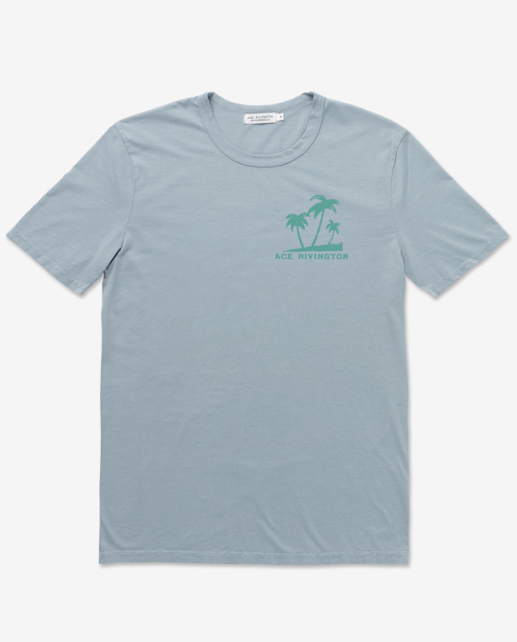 Light blue Supima Tee - Crewneck SS - Mahalo Horizon Blue t-shirt with a small green graphic of palm trees and the text 'ACE RIVINGTON' on the left chest area.