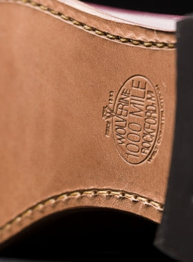 The sole of a black Ace Rivington Wolverine - 1000 Mile - Plain Toe Original Boot. The leather sole features a stamped logo that reads 'WOLVERINE 1000 MILE ROCKFORD MI USA SINCE 1883' and visible stitching around the border, highlighting the craftsmanship and durability of the boot.