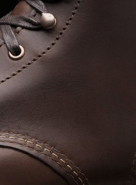 Close-up view of an Ace Rivington Plain Toe Original brown leather boot with smooth texture and detailed stitching around the toe area, featuring dark laces threaded through metal eyelets, showcasing the craftsmanship and quality of the Wolverine 1000 Mile boot.