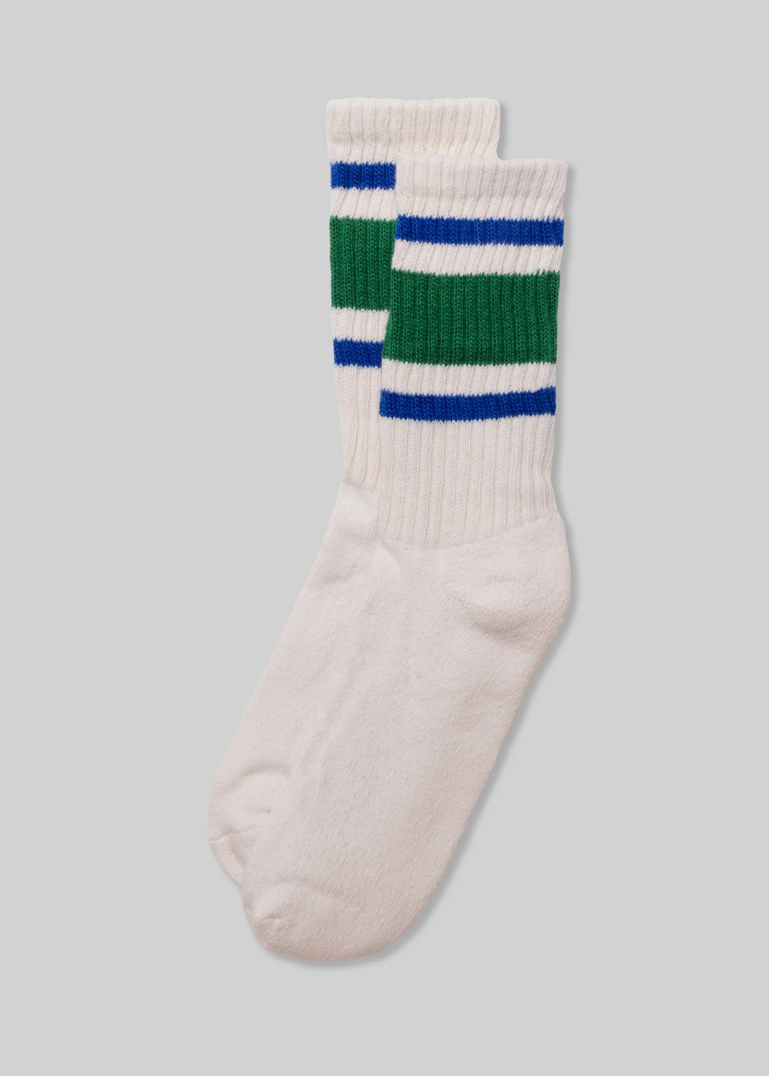 A pair of Ace Rivington American Trench Retro Stripe white socks with a ribbed upper section featuring retro stripes in green and blue. The design is reminiscent of vintage athletic socks, adding a nostalgic and stylish touch.