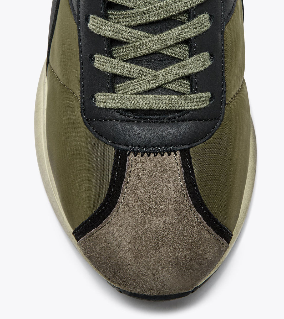 Close-up of the Ace Rivington Diadora - Mercury Elite - Beech Green, highlighting the olive green upper, brown suede toe cap, and black accents. The sneaker's design is reminiscent of classic 1970s running shoes with a modern twist.