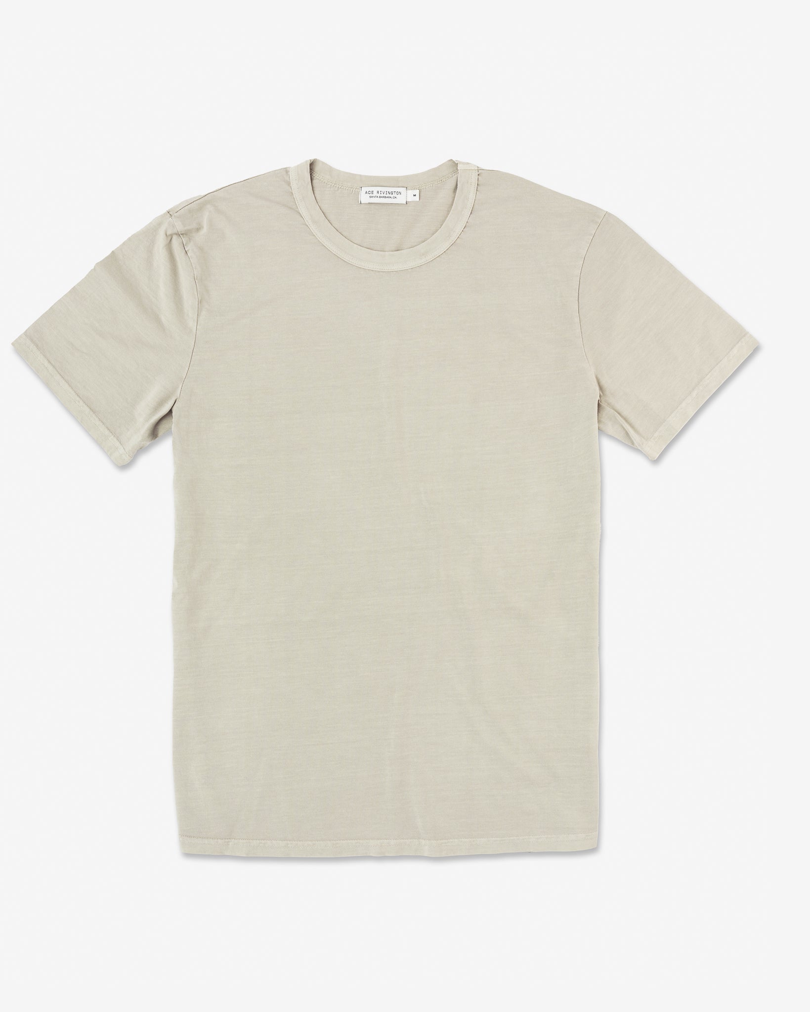 A beige-colored Ace Rivington Super Soft Supima Cotton Tee is displayed against a plain white background. The T-shirt features a classic crew neck design with short sleeves and a simple, clean look. The fabric appears soft and comfortable, emphasizing the high-quality Supima cotton material. A small label is visible at the back of the neck area.