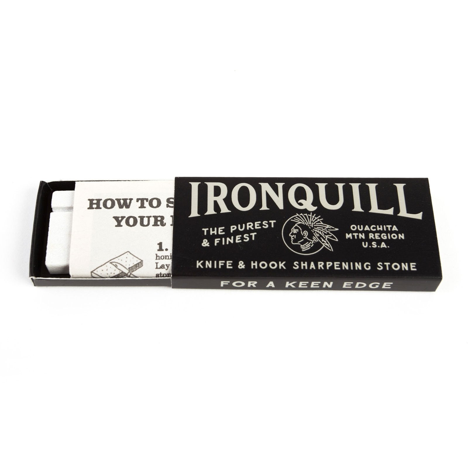 Ace Rivington Mollyjogger - Ironquill Knife and Hook Sharpening Stone packaging. The black box reads 'IRONQUILL THE PUREST & FINEST OUACHITA MTN REGION U.S.A. KNIFE & HOOK SHARPENING STONE FOR A KEEN EDGE.' The box is partially open, revealing an instruction sheet titled 'HOW TO SHARPEN YOUR...' with a visible step 1 illustration.